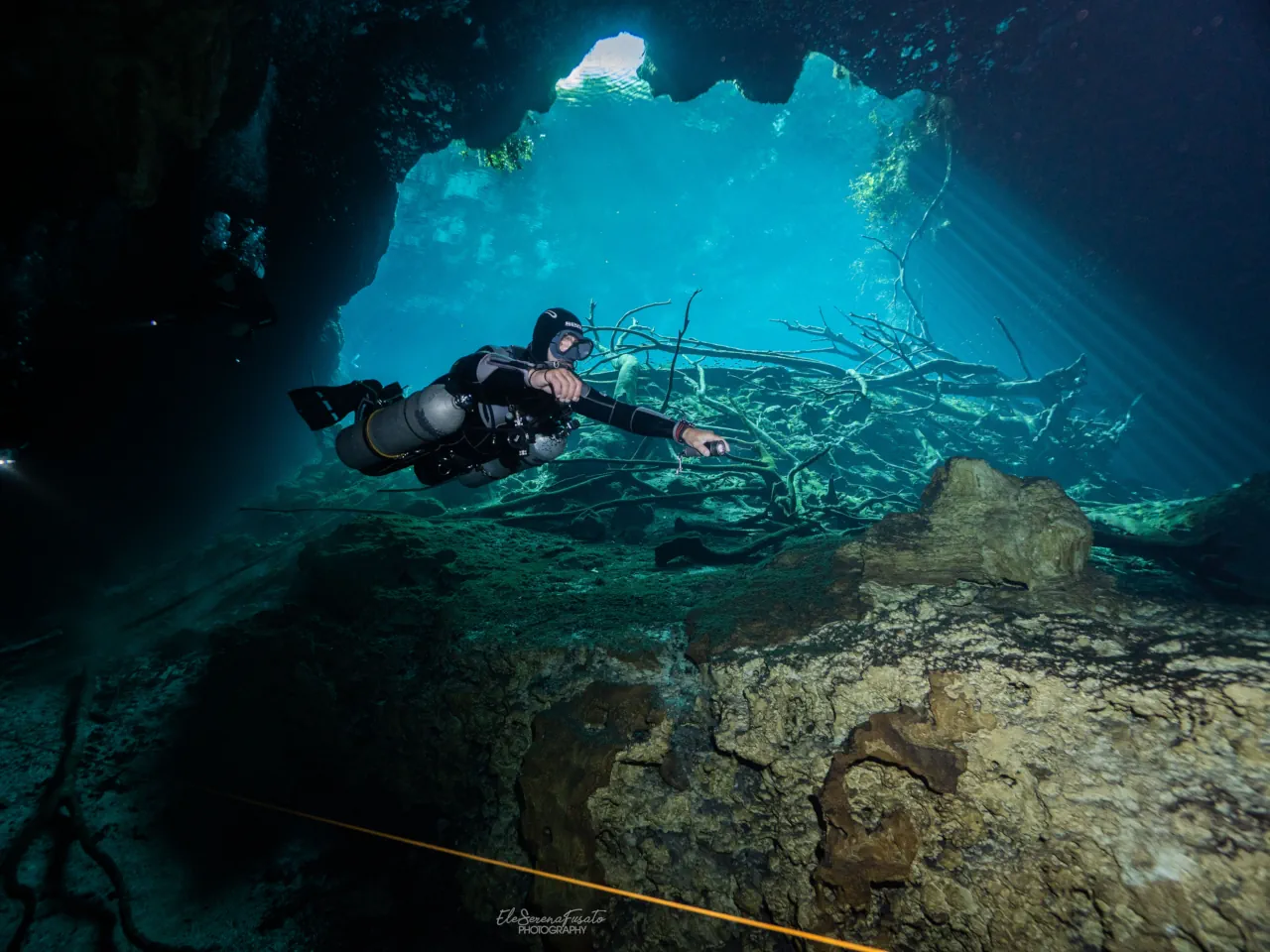 Cenote diving in Tulum with light rays and crystal clear water
