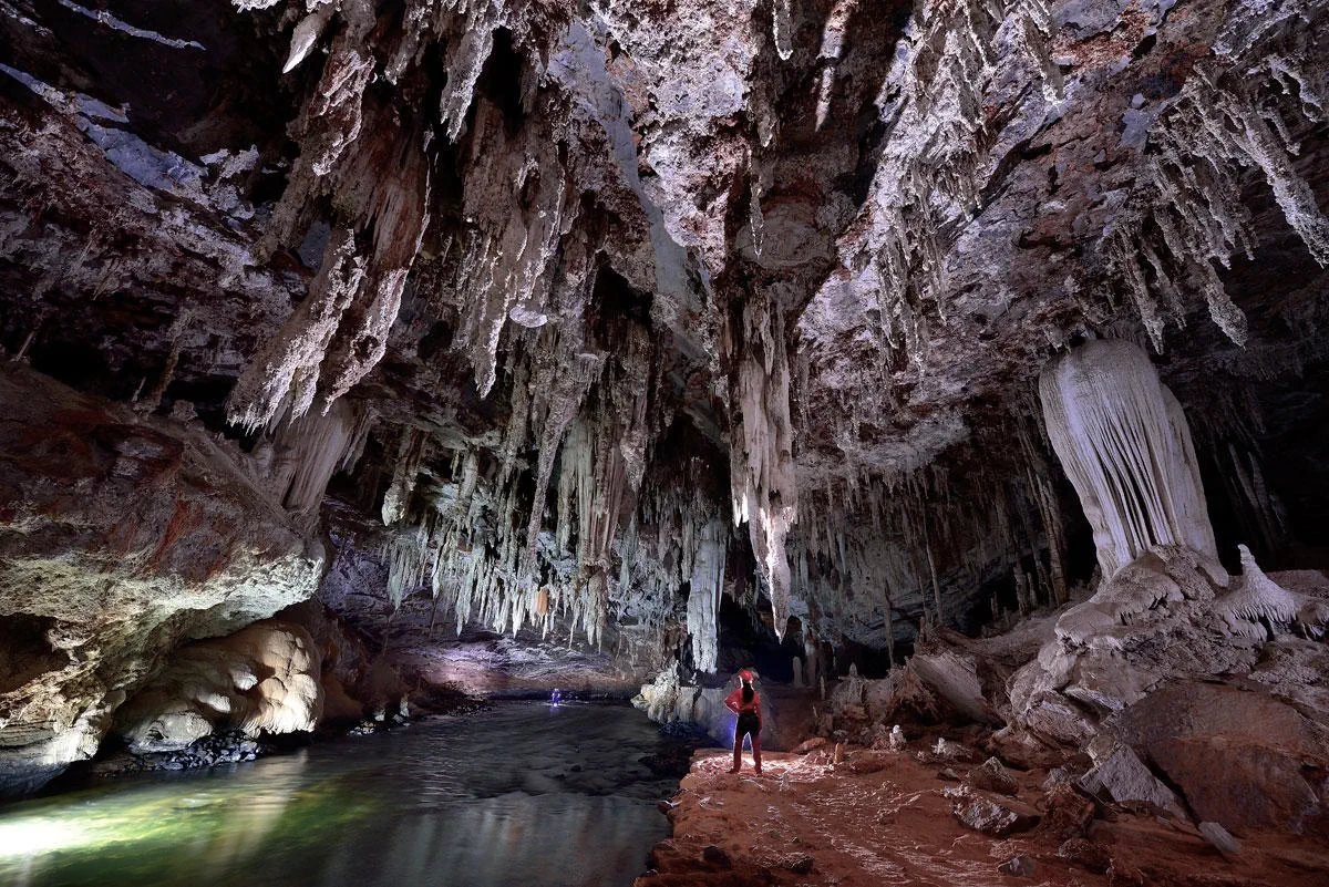 Explorers inside a mineral waterfall chamber.