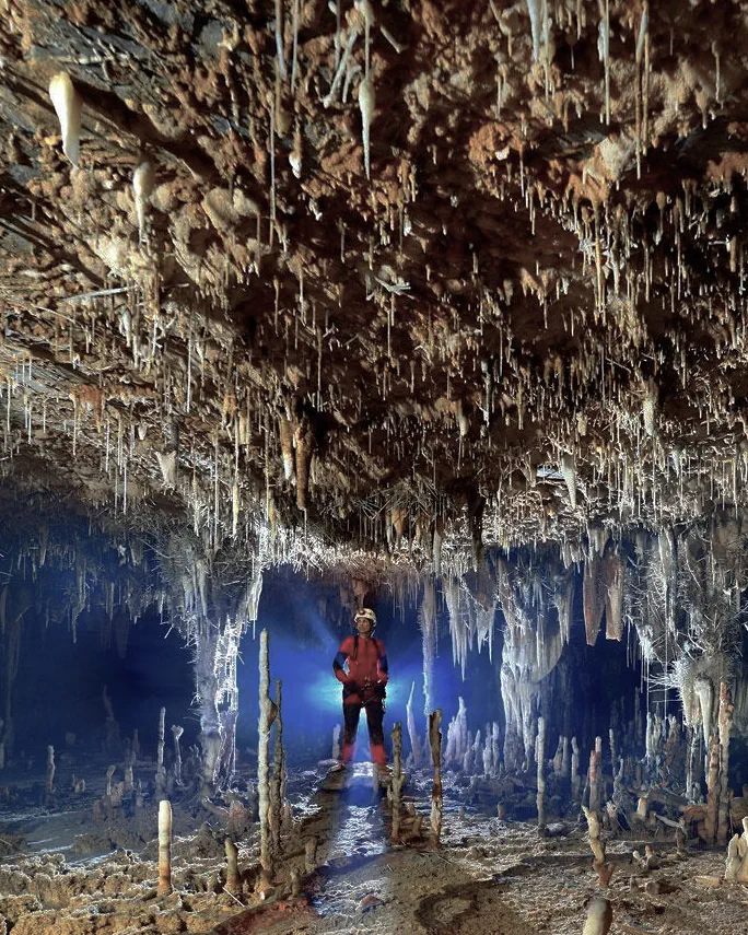 Expedition team traversing underground terrain.