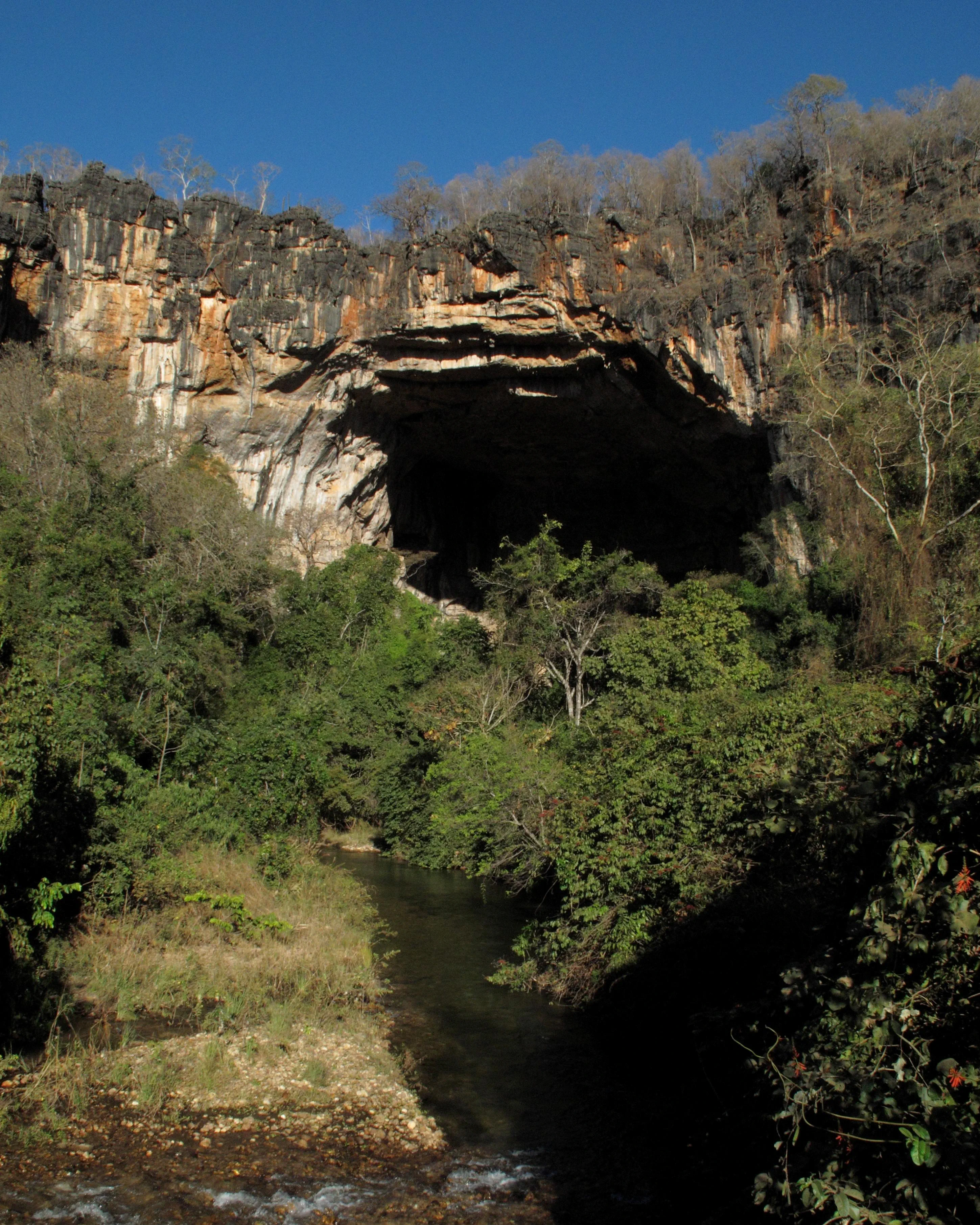 Human scale against massive cave walls.